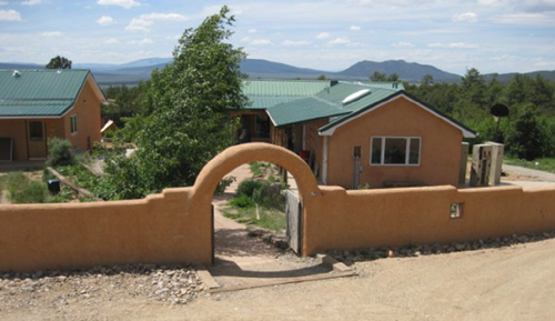 New arched entryway, gate and traditional adobe wall greets students and visitors